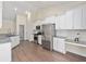 Bright kitchen with white cabinets, stainless steel appliances, and granite countertops at 5333 Abbey Park Loop, Myrtle Beach, SC 29579