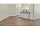Bright living area with hardwood floors, neutral paint and trim, and bar seating at the kitchen at 5333 Abbey Park Loop, Myrtle Beach, SC 29579