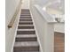 Carpeted staircase leads to the upper level, providing a seamless transition to the home's living spaces at 5333 Abbey Park Loop, Myrtle Beach, SC 29579