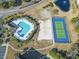 Aerial view showcases the community's pool, tennis court, and surrounding green spaces at 5801 Oyster Catcher Dr. # 912, North Myrtle Beach, SC 29582
