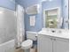 Bright bathroom with a tub and shower combination, vanity, and blue painted walls at 5801 Oyster Catcher Dr. # 912, North Myrtle Beach, SC 29582