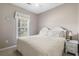 Bedroom with queen bed, neutral tones, and bright window at 5801 Oyster Catcher Dr. # 912, North Myrtle Beach, SC 29582