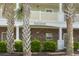 Exterior shot of building 'Ironwood 9' with palm trees and well-maintained landscaping at 5801 Oyster Catcher Dr. # 912, North Myrtle Beach, SC 29582