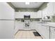 Well-lit kitchen with white cabinetry, modern appliances, and neutral tile flooring at 5801 Oyster Catcher Dr. # 912, North Myrtle Beach, SC 29582
