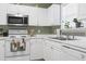 Updated kitchen features white cabinets, stainless steel microwave, and sleek countertops at 5801 Oyster Catcher Dr. # 912, North Myrtle Beach, SC 29582