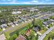 Aerial view showcases a charming neighborhood, pond, and a house with solar panels near the beach at 584 Circle Dr., Surfside Beach, SC 29575