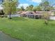 Lush backyard with a brick house, detached garage, and serene waterfront view, ideal for relaxation at 584 Circle Dr., Surfside Beach, SC 29575