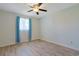 Bedroom with a ceiling fan, curtains, and updated vinyl plank flooring at 584 Circle Dr., Surfside Beach, SC 29575