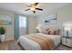 Nicely staged bedroom with a ceiling fan, bright window, and decorative artwork at 584 Circle Dr., Surfside Beach, SC 29575