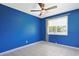 Bedroom features bright blue walls, a ceiling fan, and natural light at 584 Circle Dr., Surfside Beach, SC 29575