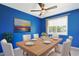 Bright dining room features bold blue walls, modern wood table, and decor at 584 Circle Dr., Surfside Beach, SC 29575