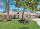 Charming single-story home with a well-manicured lawn and mature trees at 584 Circle Dr., Surfside Beach, SC 29575