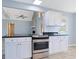 Bright kitchen features white cabinets, granite countertops, and stainless steel oven at 584 Circle Dr., Surfside Beach, SC 29575