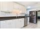 The kitchen features granite countertops, white cabinets, subway tile backsplash, and new stainless appliances at 584 Circle Dr., Surfside Beach, SC 29575