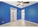 Empty living room features bright blue walls with white trim and flooring at 584 Circle Dr., Surfside Beach, SC 29575
