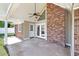 Covered patio with brick accents, a fan, and access to the backyard at 584 Circle Dr., Surfside Beach, SC 29575