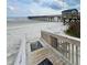 Boardwalk access to the beach offering a serene view of the pier and coastline at 6000 Ocean Blvd. N # 108, North Myrtle Beach, SC 29582