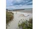 Tranquil beach vista with a charming pier stretching into the calm ocean waters at 6000 Ocean Blvd. N # 108, North Myrtle Beach, SC 29582