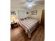 Comfortable bedroom with a queen-sized bed, ceiling fan, and hardwood floors at 6000 Ocean Blvd. N # 108, North Myrtle Beach, SC 29582