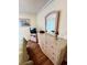 Bright bedroom with wicker dresser, lamp, and laminate wood flooring at 6000 Ocean Blvd. N # 108, North Myrtle Beach, SC 29582