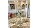 Bright dining area features a glass table, ornate chairs, and decorative accents at 6000 Ocean Blvd. N # 108, North Myrtle Beach, SC 29582