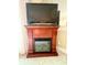 Elegant fireplace with mantle and TV creating a cozy focal point in the living space at 6000 Ocean Blvd. N # 108, North Myrtle Beach, SC 29582