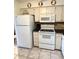 Kitchen features white appliances, cabinets and countertop at 6000 Ocean Blvd. N # 108, North Myrtle Beach, SC 29582