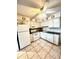 Kitchen with white appliances, cabinets and black countertop at 6000 Ocean Blvd. N # 108, North Myrtle Beach, SC 29582