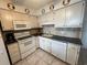 Kitchen with white cabinets, appliances, and updated countertops at 6000 Ocean Blvd. N # 108, North Myrtle Beach, SC 29582