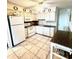 Well-lit kitchen with white appliances, cabinets and tile flooring at 6000 Ocean Blvd. N # 108, North Myrtle Beach, SC 29582