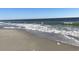 Serene ocean view with gentle waves washing ashore on a clear, sunny day at 6000 Ocean Blvd. N # 108, North Myrtle Beach, SC 29582