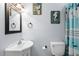 Well-lit bathroom with a unique mirror, decorative seahorse wall art, and a charming shower curtain at 6001-8050 S Kings Hwy., Myrtle Beach, SC 29575