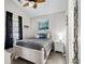 Cozy bedroom featuring a white bed frame, beach themed accents and a ceiling fan at 6001-8050 S Kings Hwy., Myrtle Beach, SC 29575