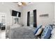 Inviting bedroom with gray bedding, ceiling fan, and dark curtains at 6001-8050 S Kings Hwy., Myrtle Beach, SC 29575