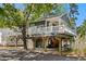 Elevated home featuring a white picket fence porch, and ground level parking and entertainment space at 6001-8050 S Kings Hwy., Myrtle Beach, SC 29575