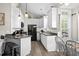 Bright kitchen featuring white cabinets, stainless steel sink, and a breakfast bar at 6001-8050 S Kings Hwy., Myrtle Beach, SC 29575