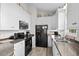 Modern kitchen with white cabinetry, stainless steel appliances, and granite countertops at 6001-8050 S Kings Hwy., Myrtle Beach, SC 29575