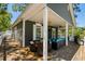Covered deck features comfortable seating, dining area, and a grill, perfect for outdoor entertaining at 6001-8050 S Kings Hwy., Myrtle Beach, SC 29575