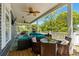Spacious covered deck featuring comfortable seating, a dining table, and ceiling fans for outdoor enjoyment at 6001-8050 S Kings Hwy., Myrtle Beach, SC 29575