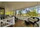 Covered porch with a rocking chair, outdoor sofa, and coffee table, offering an inviting outdoor space at 6001-8050 S Kings Hwy., Myrtle Beach, SC 29575