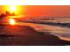 Sunrise view of a beach with waves coming in at 6001-Z55 South Kings Hwy., Myrtle Beach, SC 29575