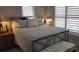 Cozy bedroom features a decorative lamp and shuttered windows for lots of light at 6001-Z55 South Kings Hwy., Myrtle Beach, SC 29575