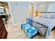 Bedroom with blue bedding and patterned bench overlooking doorway to kitchen and living space at 6001-Z55 South Kings Hwy., Myrtle Beach, SC 29575