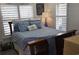 Cozy bedroom with white walls, plantation shutters and blue bedding and decor at 6001-Z55 South Kings Hwy., Myrtle Beach, SC 29575