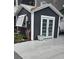 Charming shed featuring an accent-colored door and window with beautiful surrounding greenery at 6001-Z55 South Kings Hwy., Myrtle Beach, SC 29575