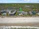 Aerial photo of beachfront condos with a pool, boardwalk, and scenic lake views at 601 Retreat Beach Circle # 215, Pawleys Island, SC 29585