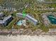 Aerial view of a condo complex overlooking a pool, beach, and lakeside neighborhood at 601 Retreat Beach Circle # 215, Pawleys Island, SC 29585
