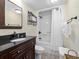 Bathroom featuring dark vanity, tiled floors, shower and tub combination perfect for relaxation at 601 Retreat Beach Circle # 215, Pawleys Island, SC 29585