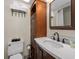 Bathroom featuring stylish vanity with solid surface countertop, storage, and decorative mirror at 601 Retreat Beach Circle # 215, Pawleys Island, SC 29585