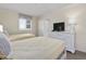 Comfortable bedroom with two beds, a TV, and ample storage space for a relaxing vacation at 601 Retreat Beach Circle # 215, Pawleys Island, SC 29585